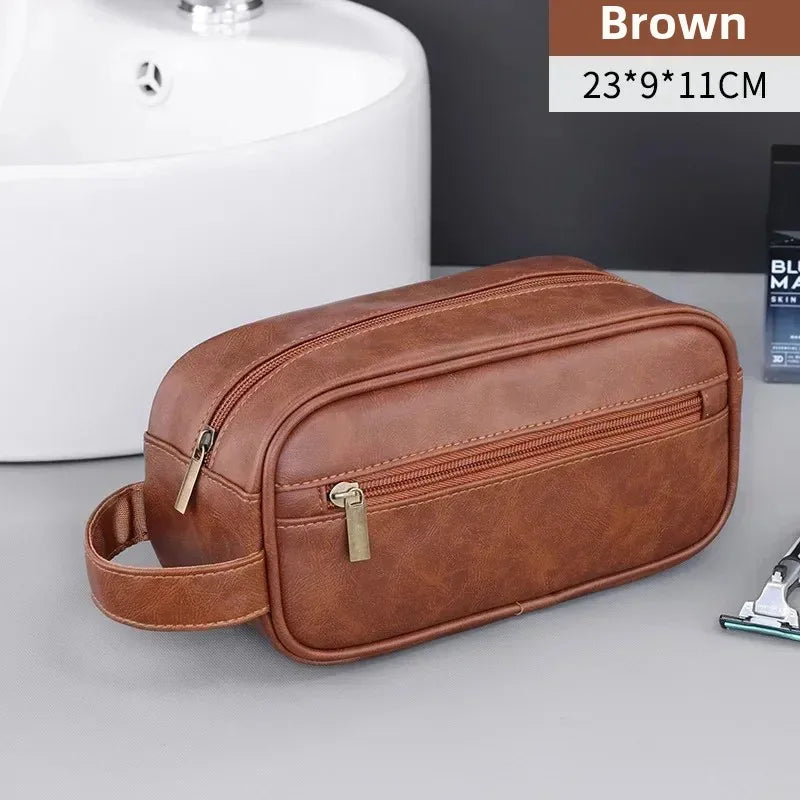 Brown PU leather travel toiletry bag with organizer pockets shown on a gray surface.