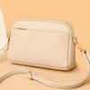 A light beige PU leather trendy shoulder crossbody bag with gold hardware shown against a neutral background.