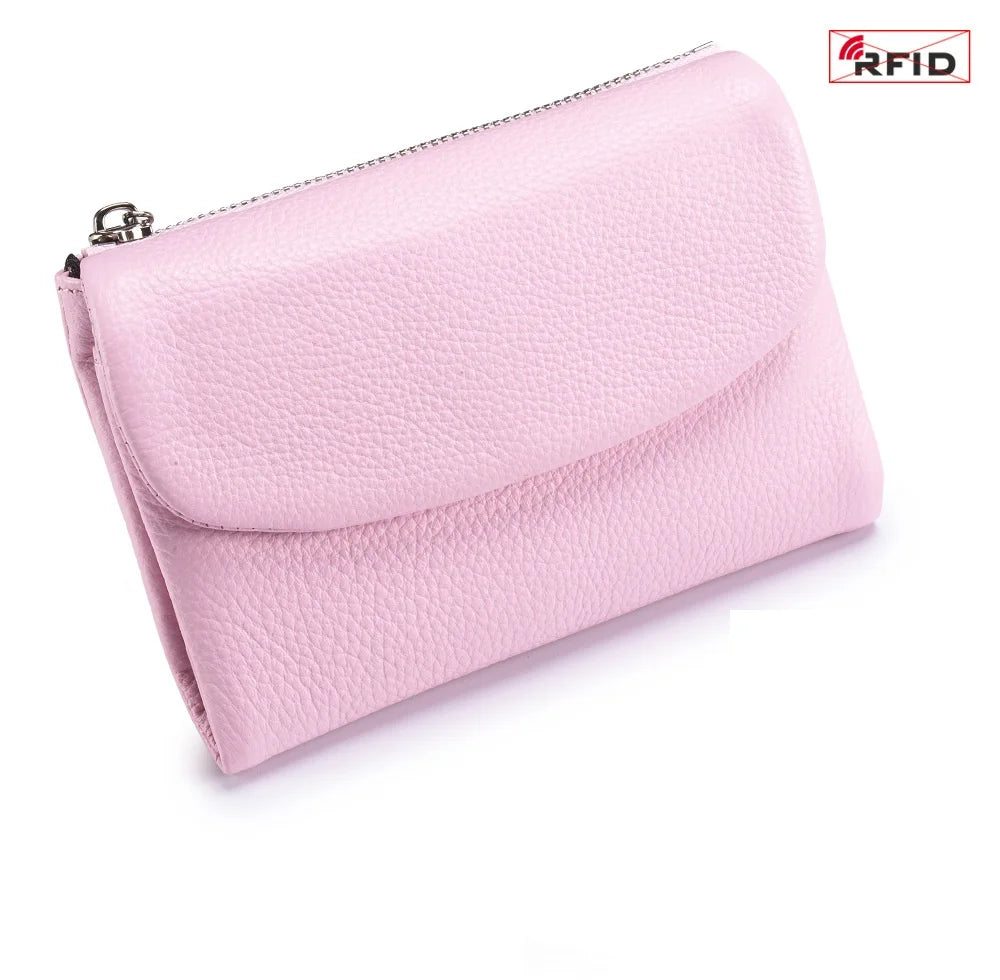 A pink genuine leather mini card holder wallet with a silver zipper visible.