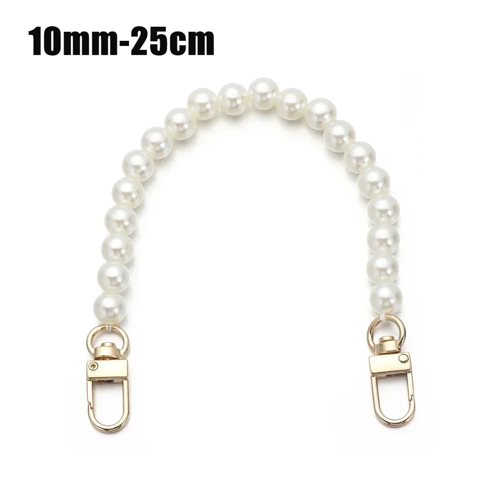 A strand of white pearls used as a strap for a handbag or purse.