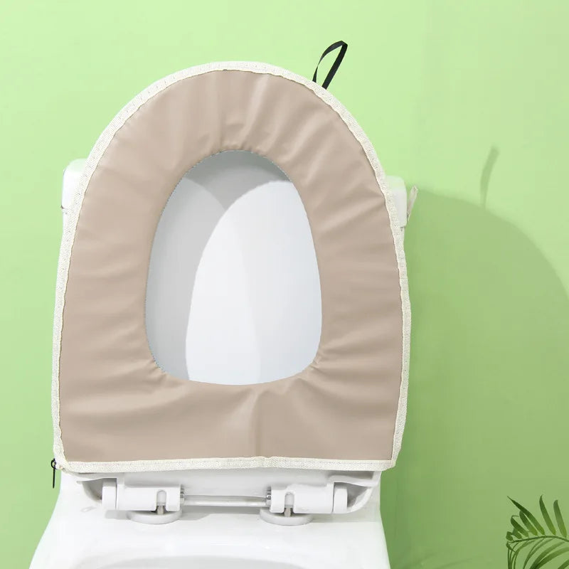 A beige plush waterproof toilet seat cover is installed on a white toilet bowl.