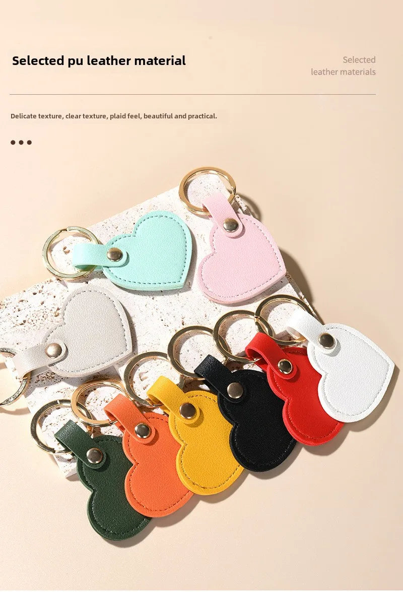 A collection of colorful, heart-shaped PU leather keychains in pastel and vibrant shades displayed on a light background.