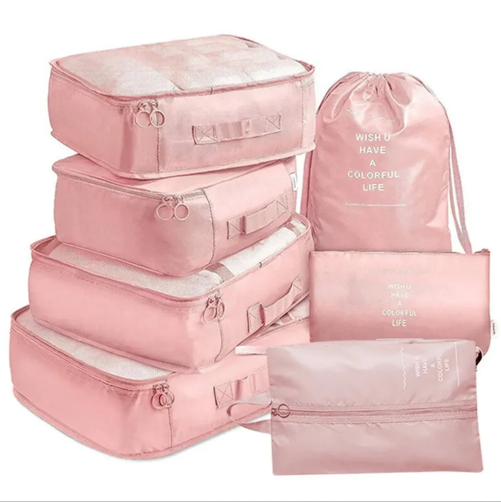 A set of seven pink folding travel organizer bags and storage pouches.