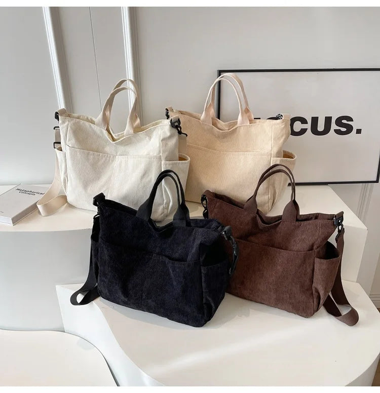 A collection of multi-pocket tote bags in cream, beige, and dark brown corduroy fabric displayed on a white surface.