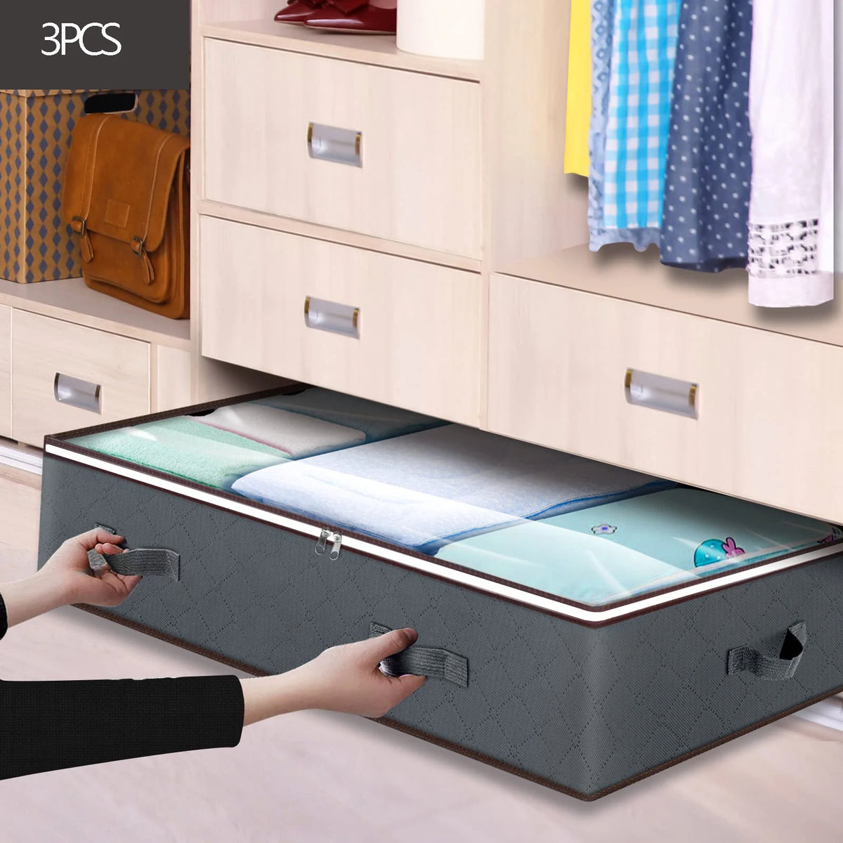 Three under bed storage organizer bins being placed into a wooden drawer unit.