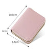 A light pink heart-shaped cartoon print zipper wallet with multiple card slots shown from above.