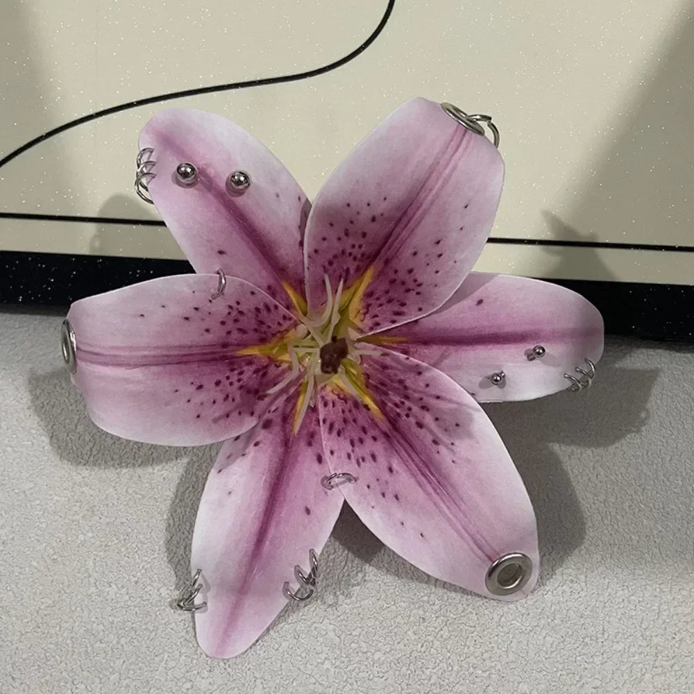 A realistic pink orchid flower is displayed, featuring purple markings and metal findings for a keychain.