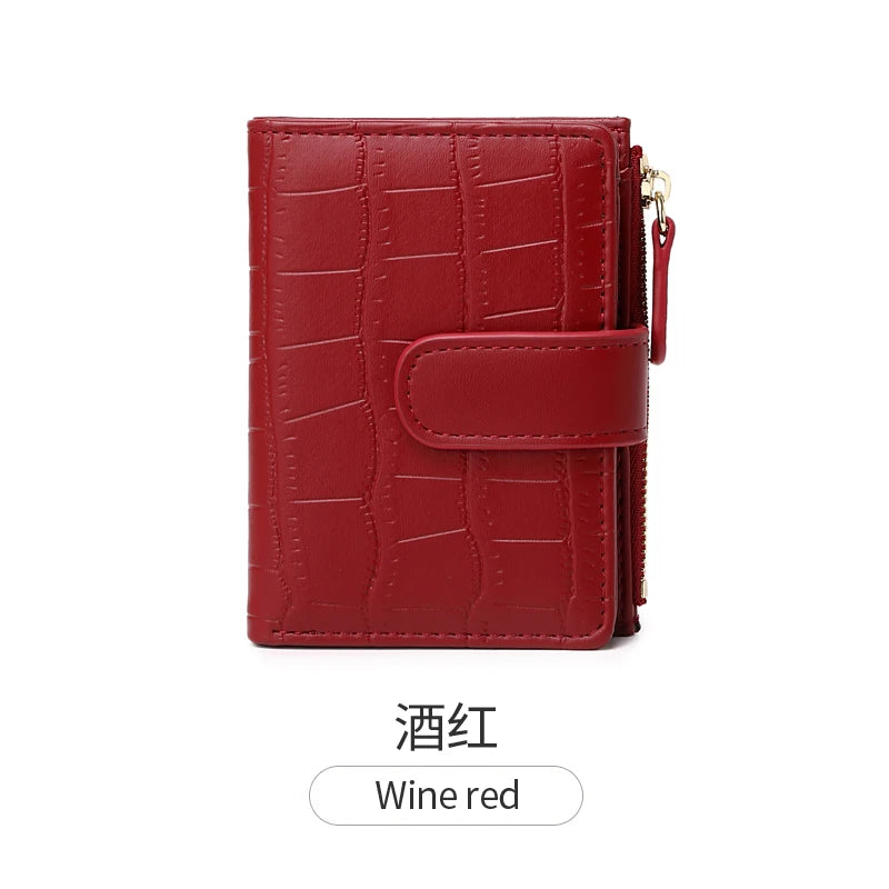 A deep red women's PU leather bifold wallet with a quilted texture and zipper closure.
