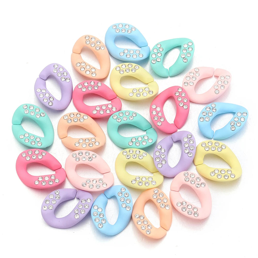 A collection of colorful acrylic link chain connectors in various pastel shades and glitter finishes.