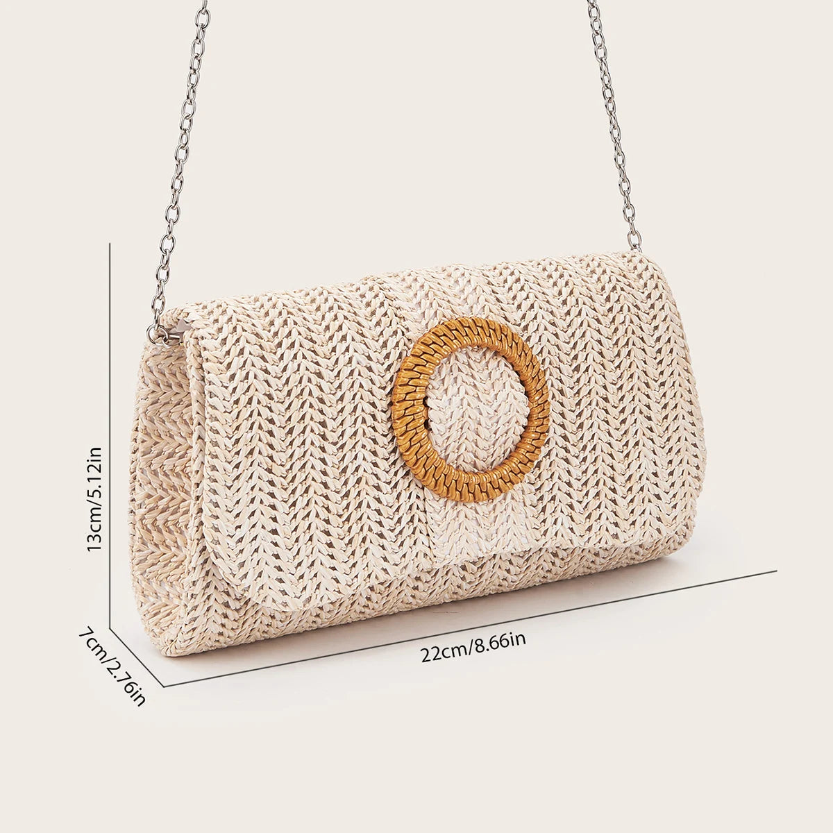 A beige woven straw envelope clutch with a round leather detail and silver chain strap.