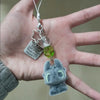 A silver keychain pendant featuring a Toothless cartoon character charm hanging from a silver chain.