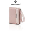 A light pink Baellerry zip-around wallet with card slots and a leather strap.