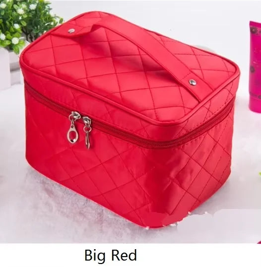 A red quilted cosmetic storage box with a zipper and hardware is shown on a white surface.