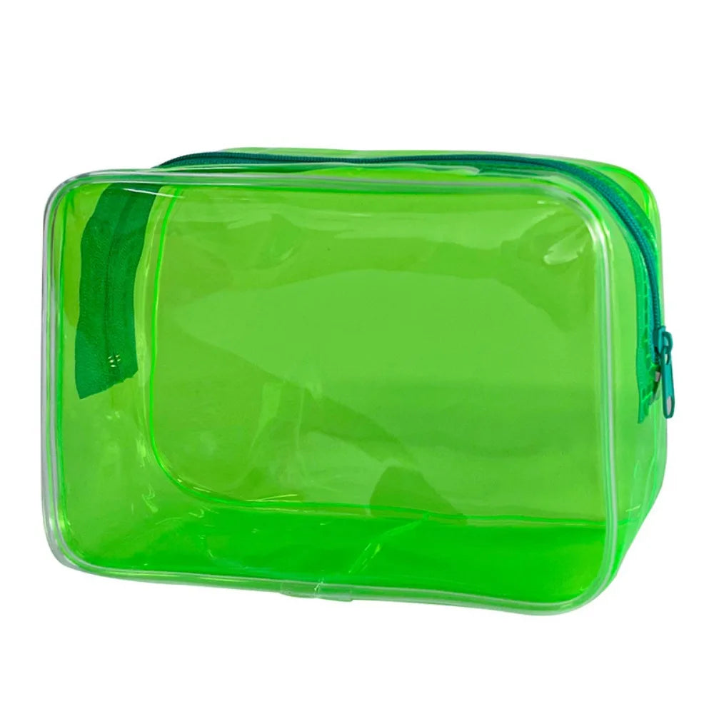 A transparent green PVC travel makeup bag with a zipper closure.