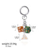 A silver keychain charm featuring three acrylic dice with numbers and a triangular piece.