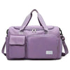 A lavender large capacity travel duffle bag with padded compartments and shoulder straps.
