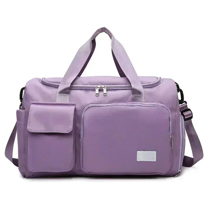 A lavender large capacity travel duffle bag with padded compartments and shoulder straps.