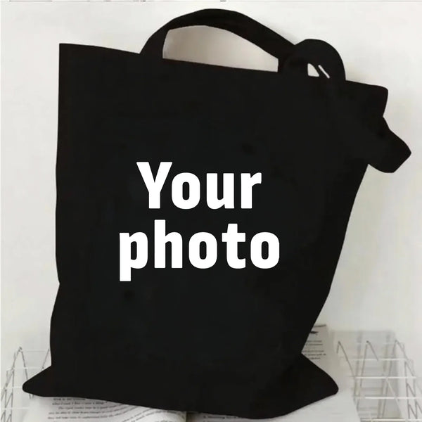 Schwarze Canvas-Einkaufstasche mit weißer Aufschrift „Your photo“