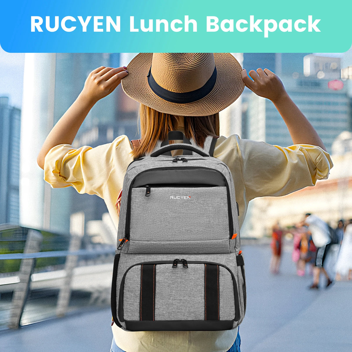 A woman wearing a yellow shirt is holding a gray insulated lunch backpack outdoors.
