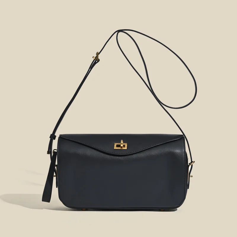 A dark navy genuine leather square shoulder crossbody bag with a gold hardware strap.