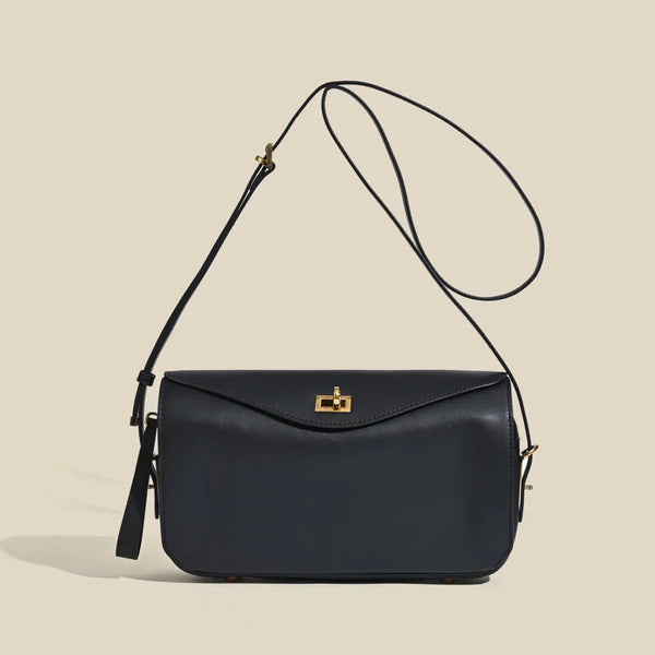 A dark navy genuine leather square shoulder crossbody bag with a gold hardware strap.