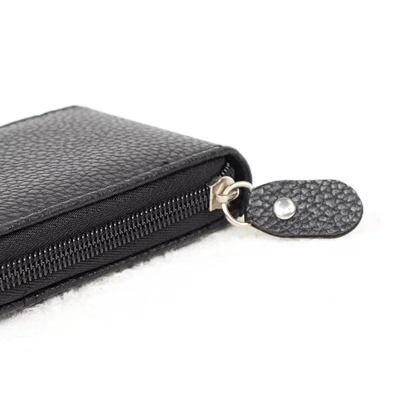 Black leather card holder wallet with a zipper closure and a textured flap.