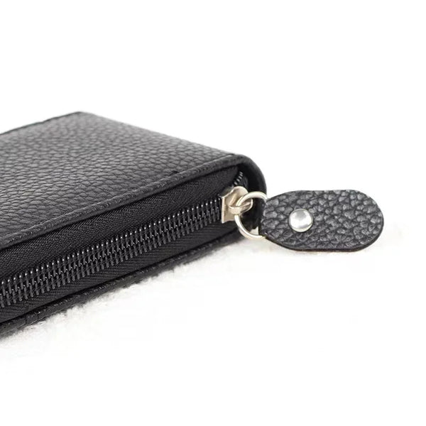 Black leather card holder wallet with a zipper closure and a textured flap.