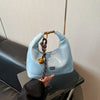 A light blue retro PU leather shoulder bag with a gold chain strap resting on a dark surface.