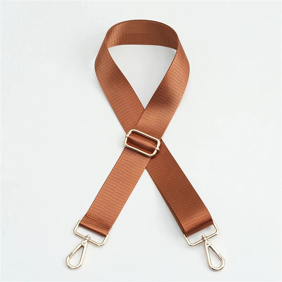A brown nylon adjustable shoulder strap with a metal buckle and clasps.