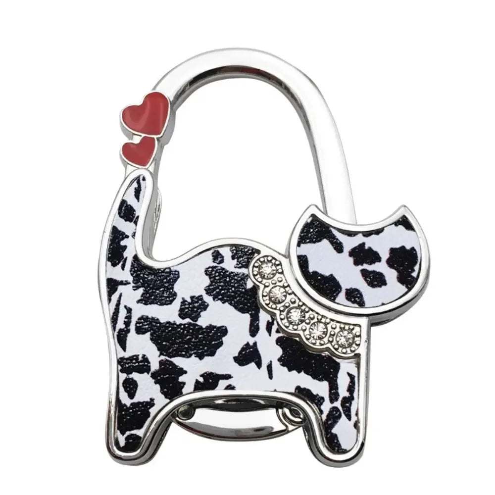 Silver cat-shaped handbag hooks with a red heart detail