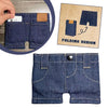 A pair of dark blue denim shorts with a folding design feature shown next to a card.