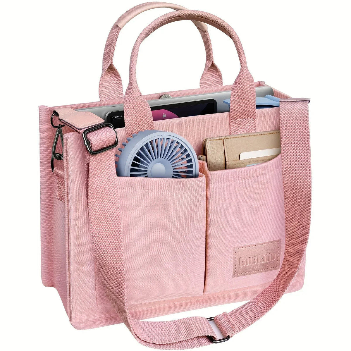 A pink canvas tote handbag with leather accents and a mesh lining, featuring two separate compartments.