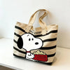A canvas shoulder bag featuring Snoopy in a black and white striped pattern with a red bowl of food.