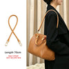 A tan leather shoulder strap is shown next to a brown leather handbag being carried by a person.