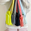 A collection of adjustable water bottle carrier bags in various colors, including yellow, gray, navy, and pink, worn on a whi