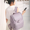 A woman is carrying a light purple insulated picnic cooler backpack while wearing a white top and skirt.