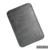 A dark gray genuine leather card holder with a folded design.