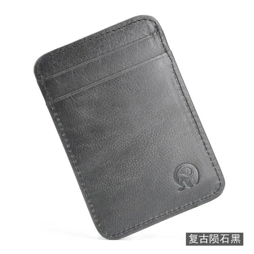 A dark gray genuine leather card holder with a folded design.