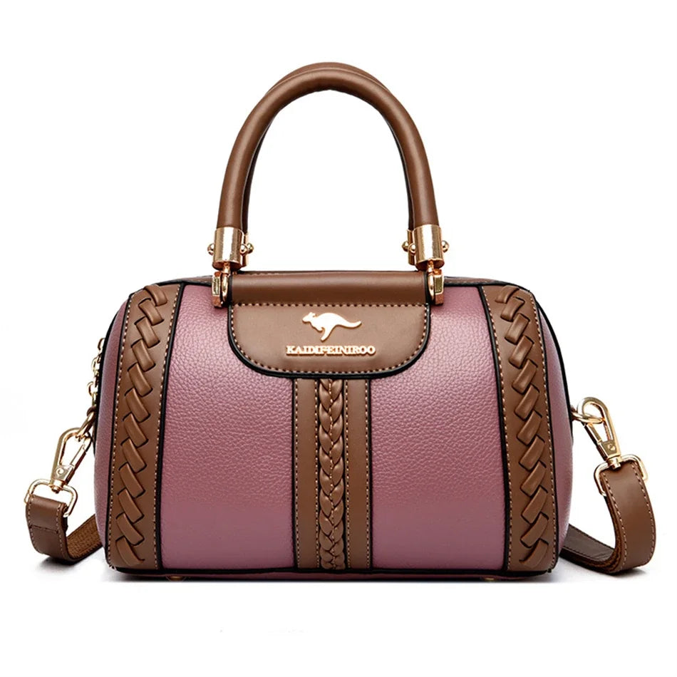 A brown leather shoulder bag with gold hardware and a woven pattern in dusty pink.