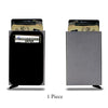 A slim metal pop-up card holder wallet shown in black and gray colors.