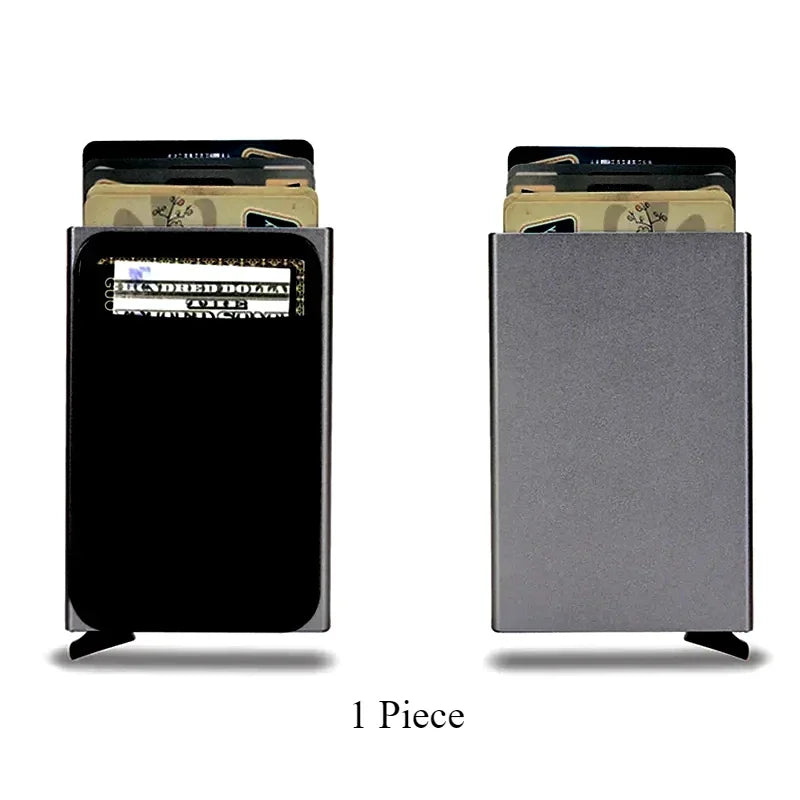 A slim metal pop-up card holder wallet shown in black and gray colors.