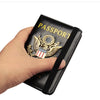A hand holds a black leather passport holder featuring a gold US Eagle badge and the word PASSPORT
