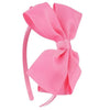 A pink ribbed fabric bow headband is shown against a white background.