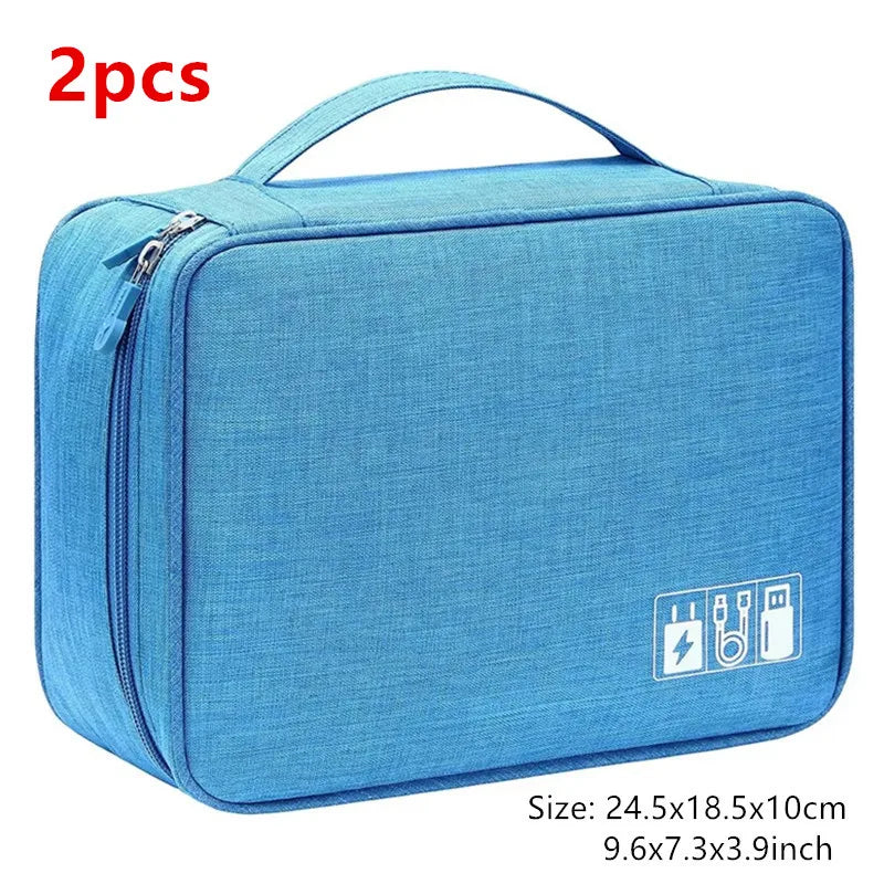 A light blue portable digital organizer storage pouch with a zipper and handle.