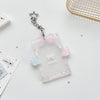 Clear acrylic photocard holder with a pink ribbon and a silver star charm