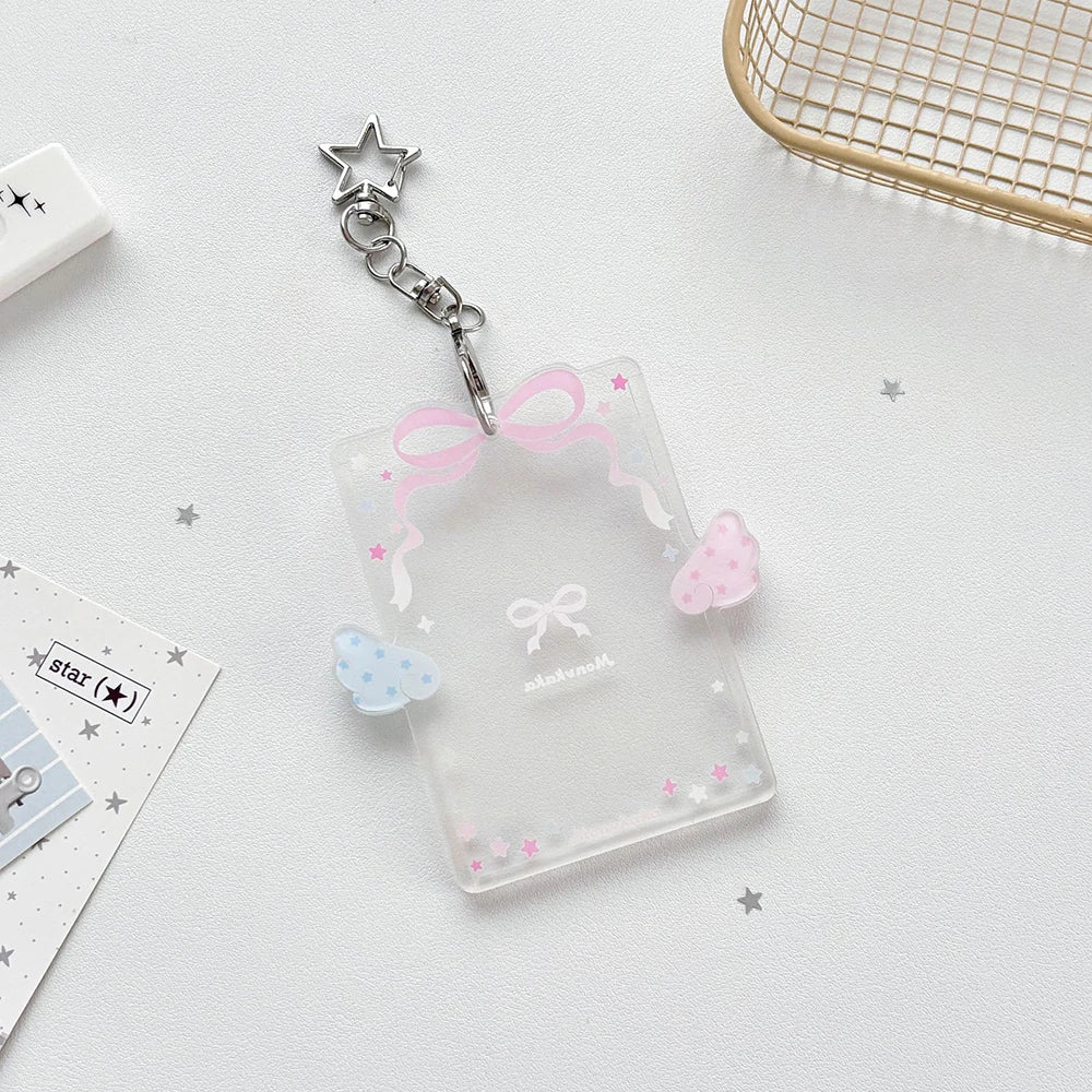 Clear acrylic photocard holder with a pink ribbon and a silver star charm
