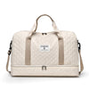 A beige durable nylon travel duffle bag with light beige straps and a quilted pattern.