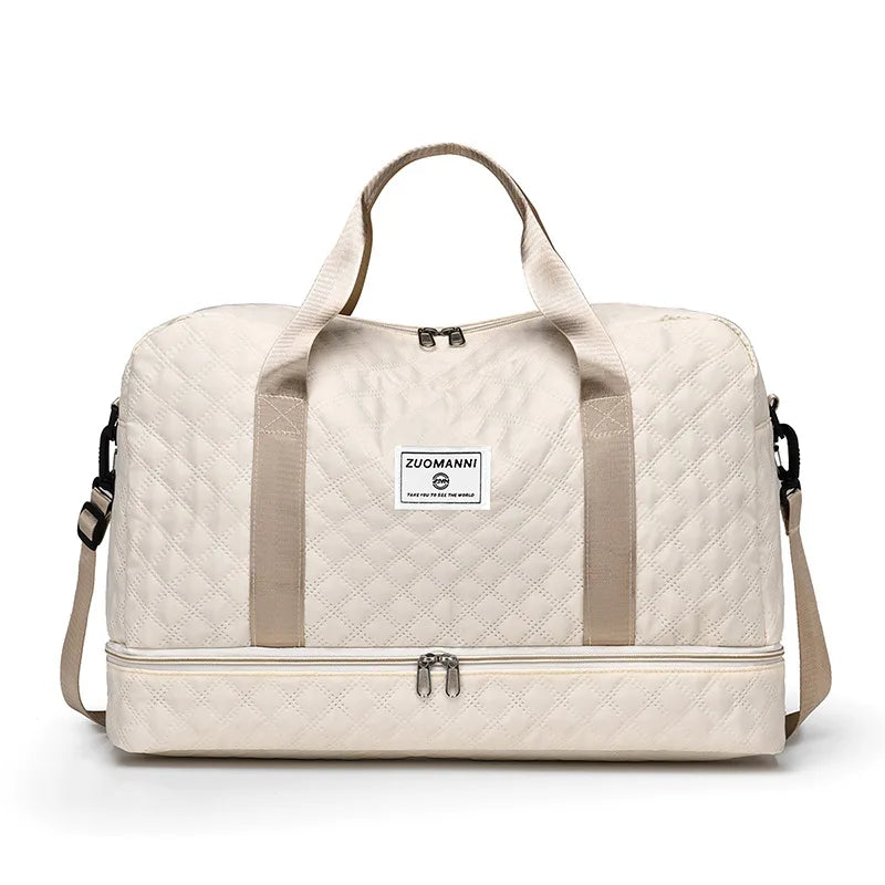 A beige durable nylon travel duffle bag with light beige straps and a quilted pattern.