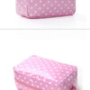 A pink waterproof cosmetic storage bag with white polka dots, shown from the top and side.
