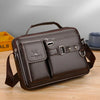 A dark brown men's PU leather crossbody shoulder bag with a flap and strap resting on a wooden surface.